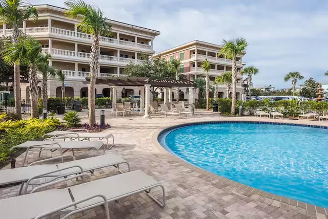 a view of a building with a yard and sitting area