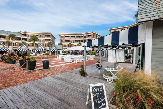 a view of a swimming pool with outdoor seating and plants
