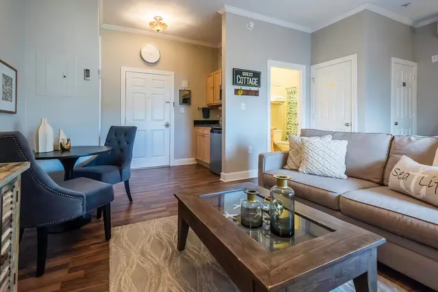 a living room with furniture and wooden floor