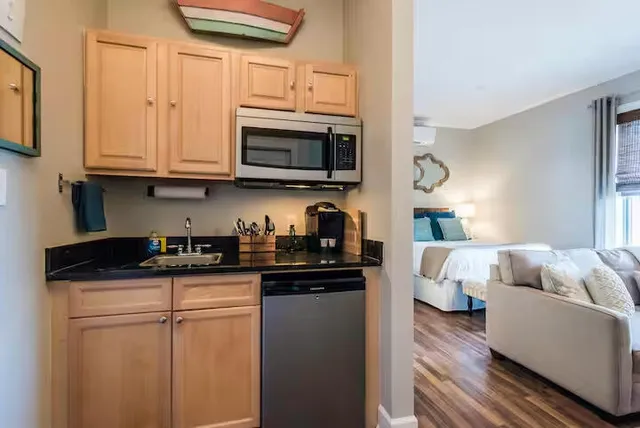 a kitchen with stainless steel appliances granite countertop a sink and a microwave