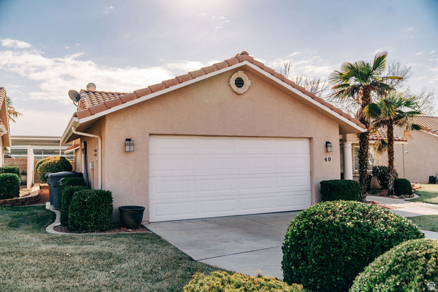 1825 West Mathis Park Place, Unit 40 St. George, UT 84770 - Photo 4 of 28 Mediterranean / spanish house with a tiled roof, stucco siding, a garage, and concrete driveway