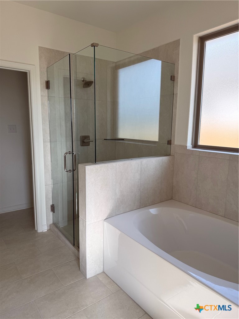 7117 Touchstone Drive Temple, TX 76502 - Photo 11 of 13 a bathroom with a bathtub and a shower