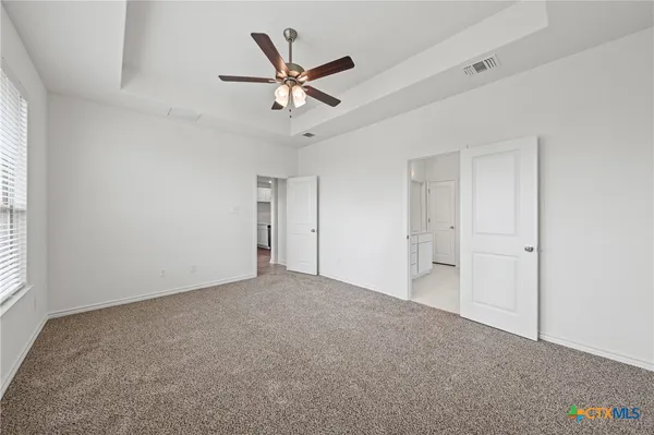 a view of an empty room and a window