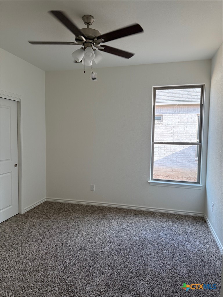 7117 Touchstone Drive Temple, TX 76502 - Photo 9 of 13 an empty room with a window and a fan