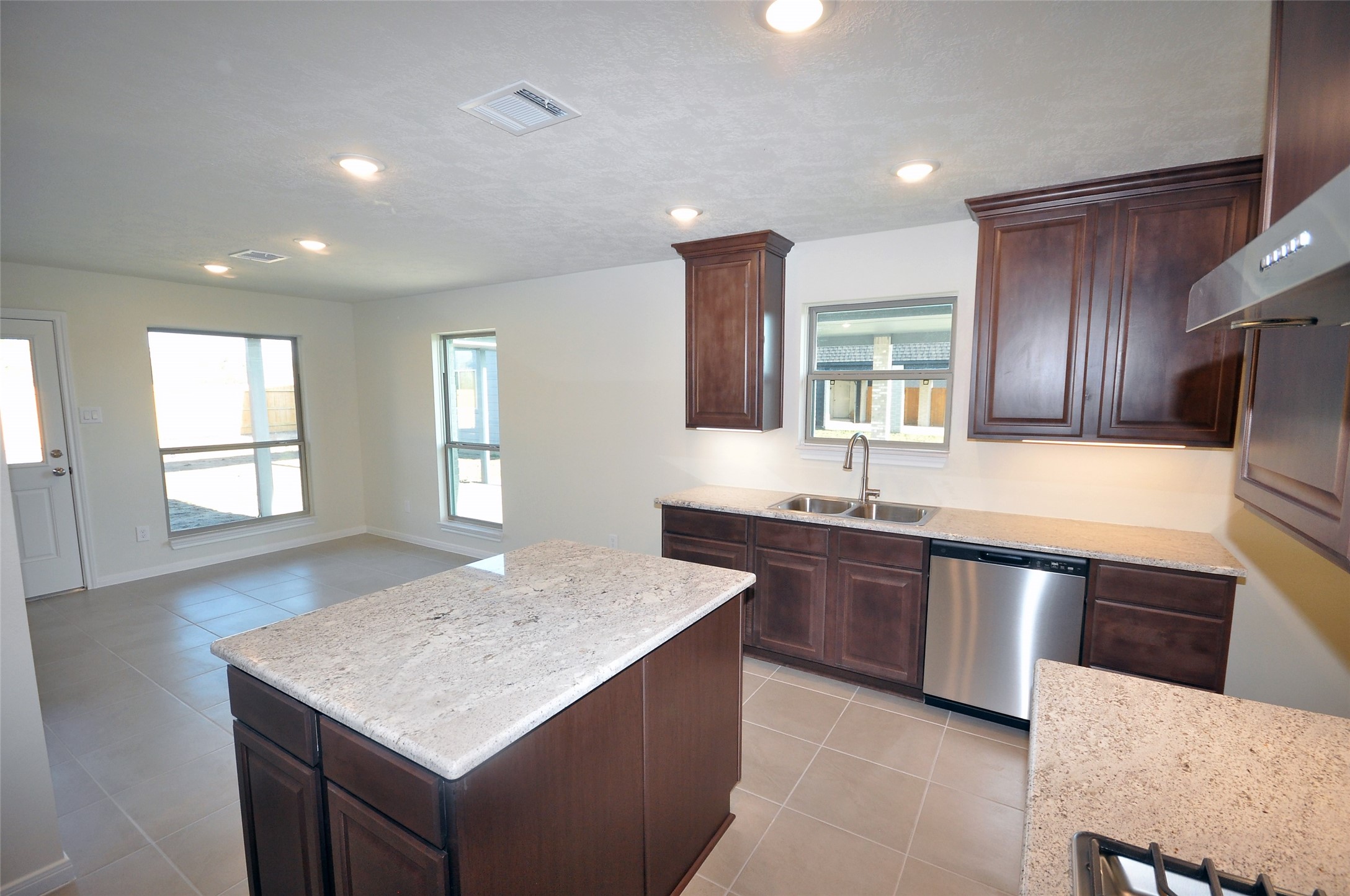 3502 Bahia Road League City, TX 77573 - Photo 11 of 40 a kitchen with stainless steel appliances granite countertop wooden cabinets a sink and dishwasher
