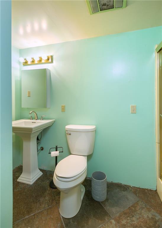3400 Pittsburgh Road Perryopolis, PA 15473 - Photo 17 of 23 a bathroom with a toilet sink and mirror