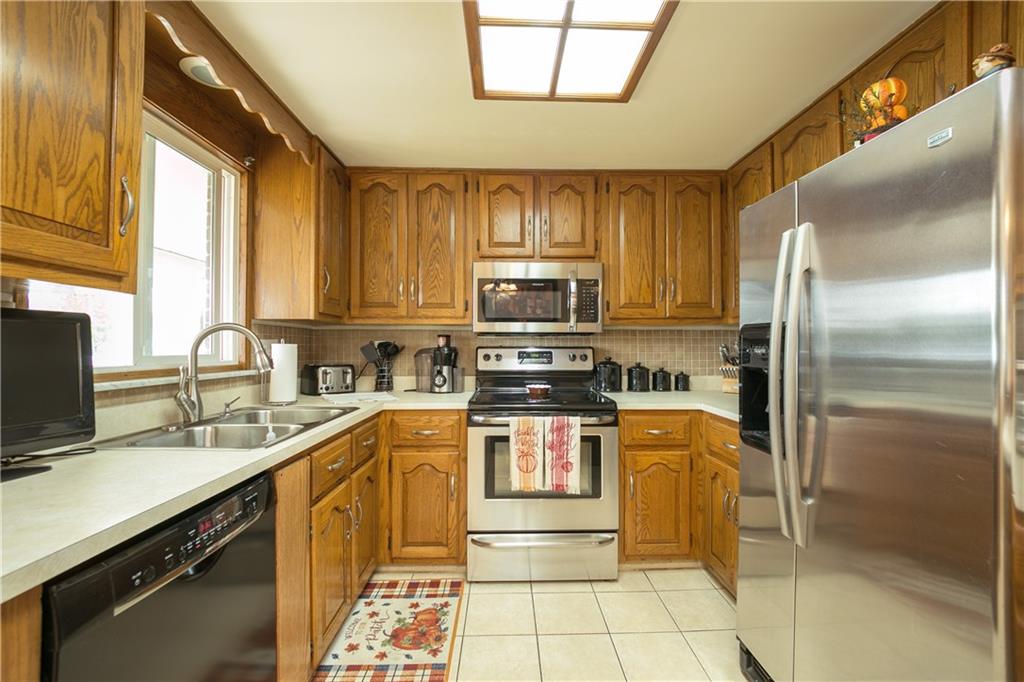 3400 Pittsburgh Road Perryopolis, PA 15473 - Photo 6 of 23 a kitchen with stainless steel appliances granite countertop a sink stove and refrigerator