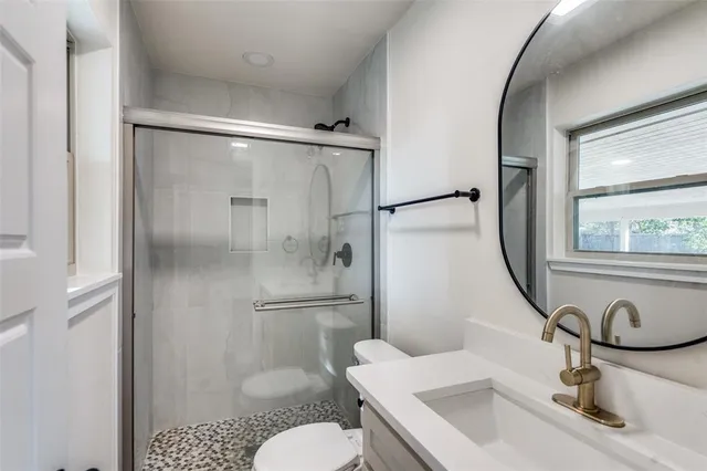 a bathroom with a sink toilet and shower