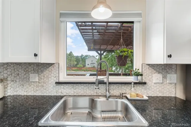 a kitchen with a sink and a window