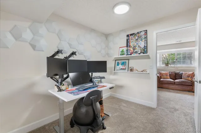 a workspace with furniture and ceiling fan