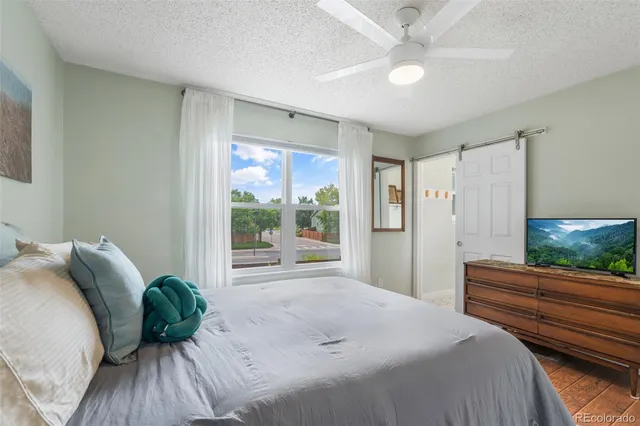 a bedroom with a bed and a large window