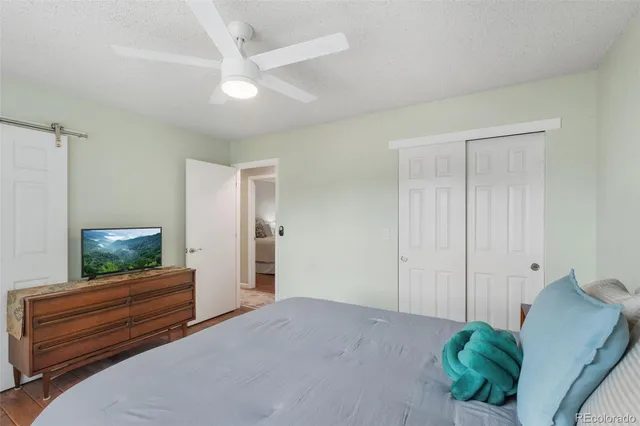 a bedroom with a bed and a television