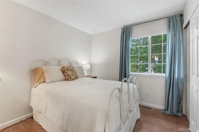 a bed sitting in a bedroom next to a window