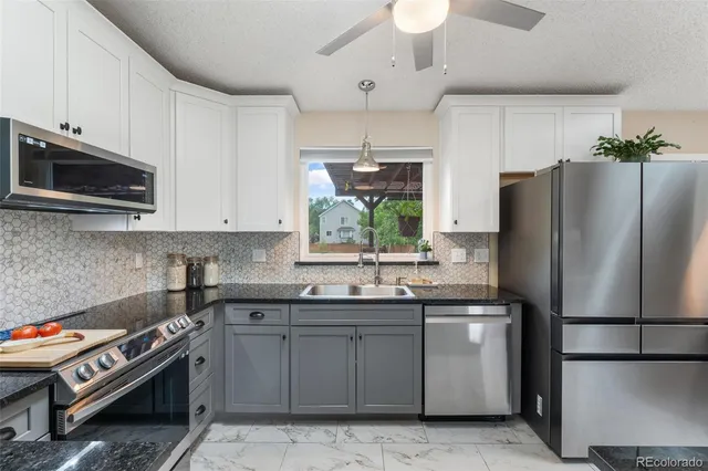 a kitchen with a sink stainless steel appliances and cabinets