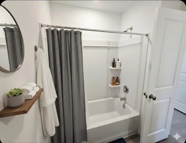 a bathroom with a shower and a tub