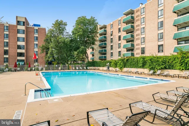 a view of swimming pool with outdoor seating and city view