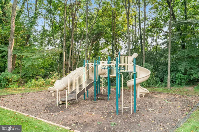 a view of a chair and table in backyard of the house