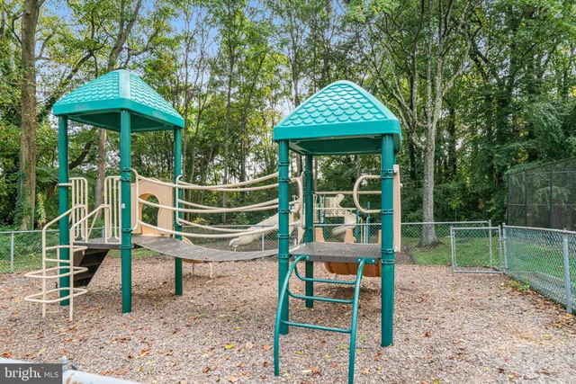 a view of a chair and table in the backyard