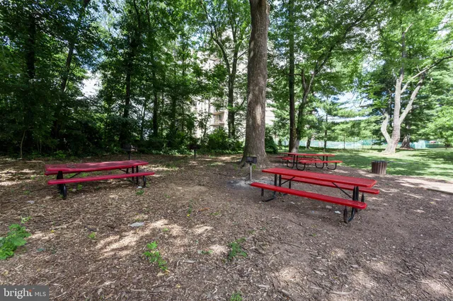 a backyard of a house with wooden fence and a bench