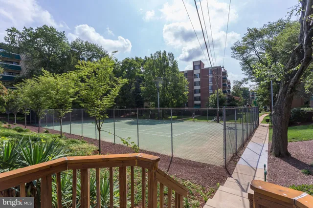 a view of a balcony with floor to ceiling windows and wooden fence