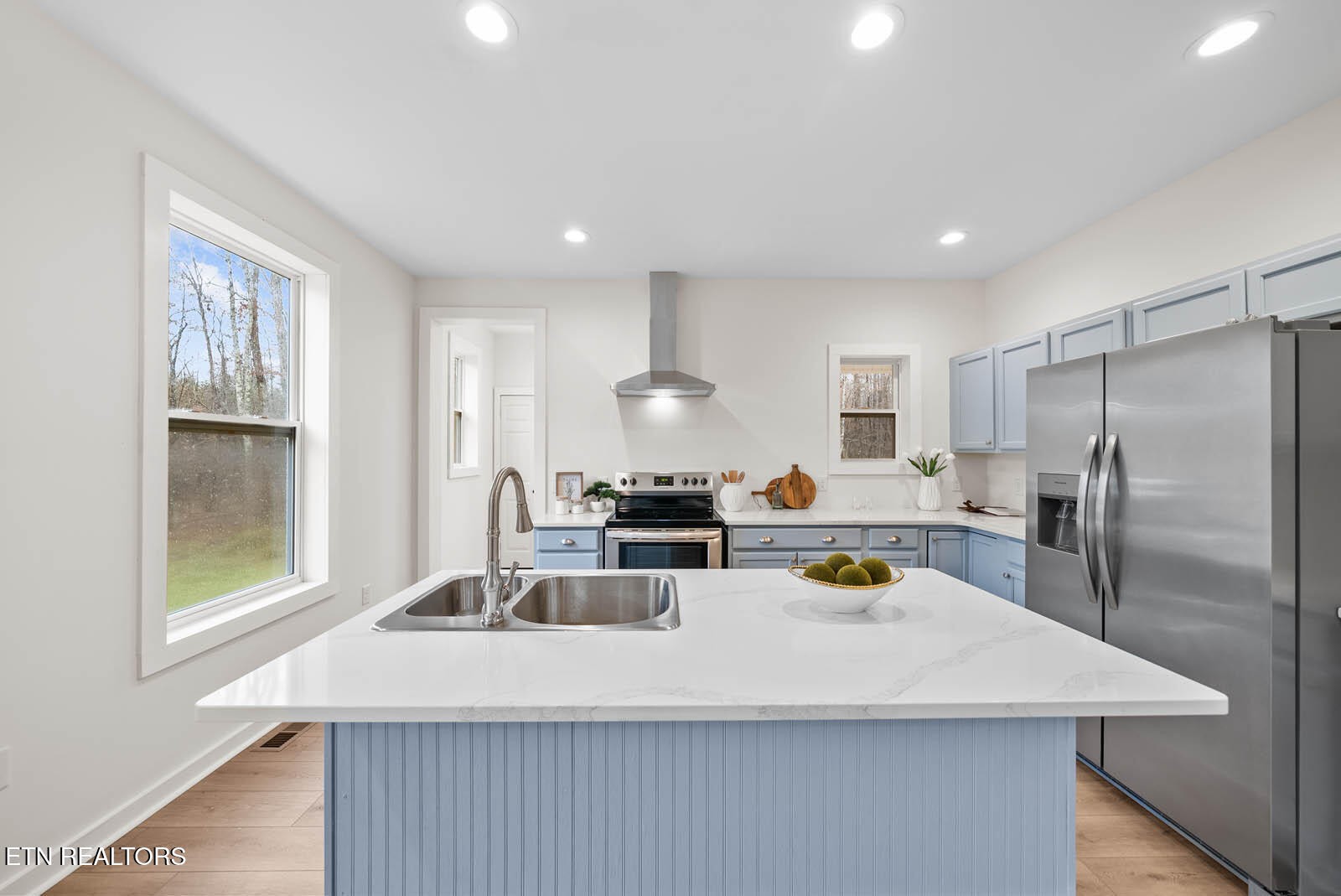 1023 West Laurel Way Monterey, TN 38574 - Photo 14 of 60 a kitchen with a refrigerator a stove a sink and a dining table with wooden floor