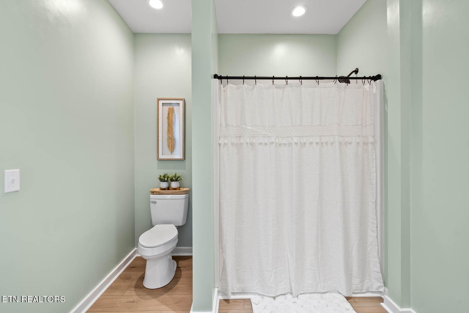 1023 West Laurel Way Monterey, TN 38574 - Photo 21 of 60 a white toilet sitting next to a shower curtain