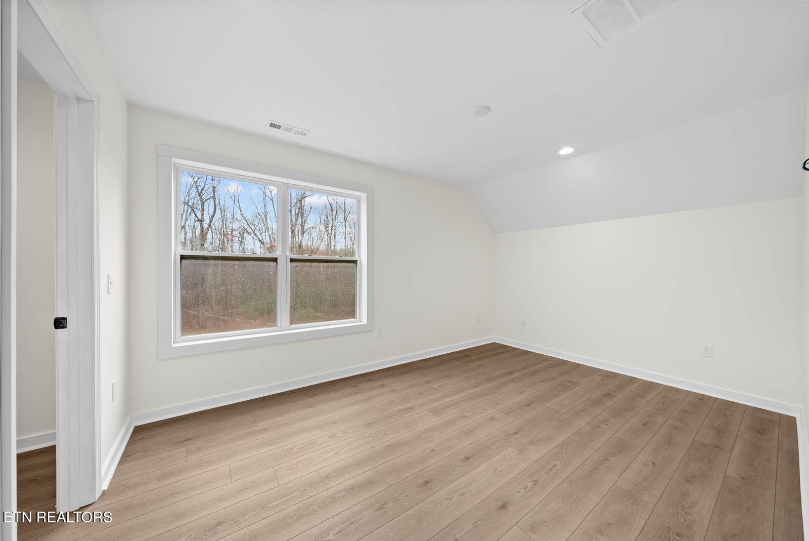 1023 West Laurel Way Monterey, TN 38574 - Photo 31 of 60 an empty room with wooden floor and windows