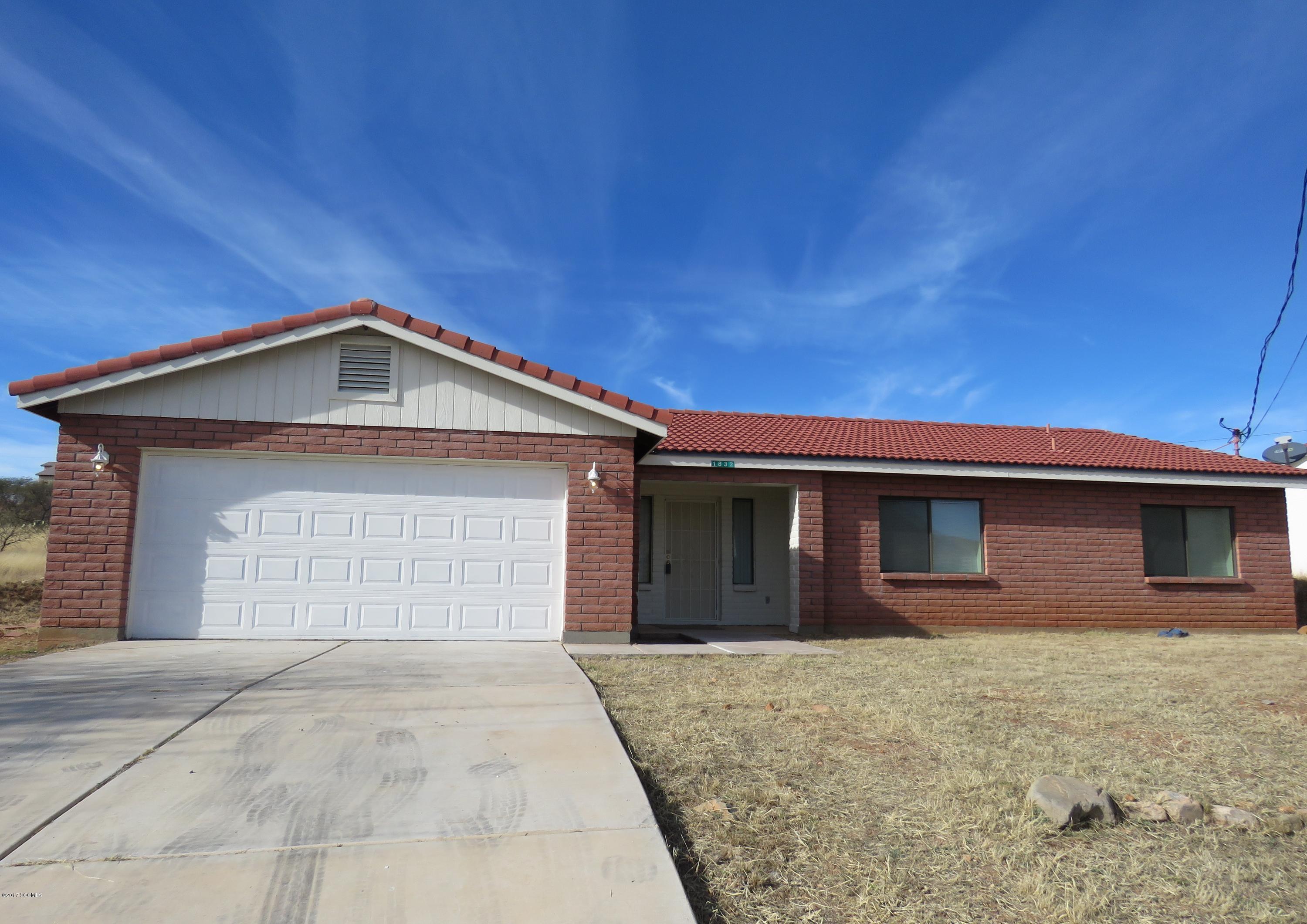 1832 Circulo Canada Rio Rico, AZ 85648 - Photo 1 of 14 a front view of the house with a yard
