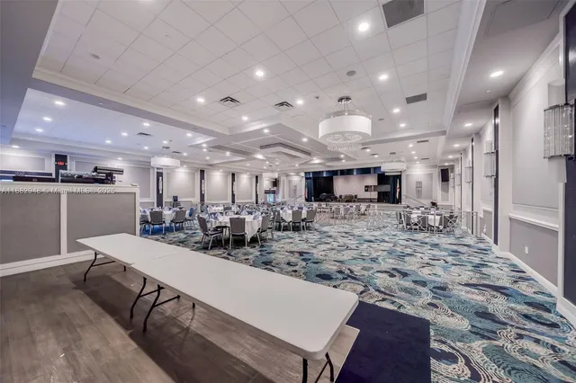 an aerial view of residential houses with outdoor space and lake view