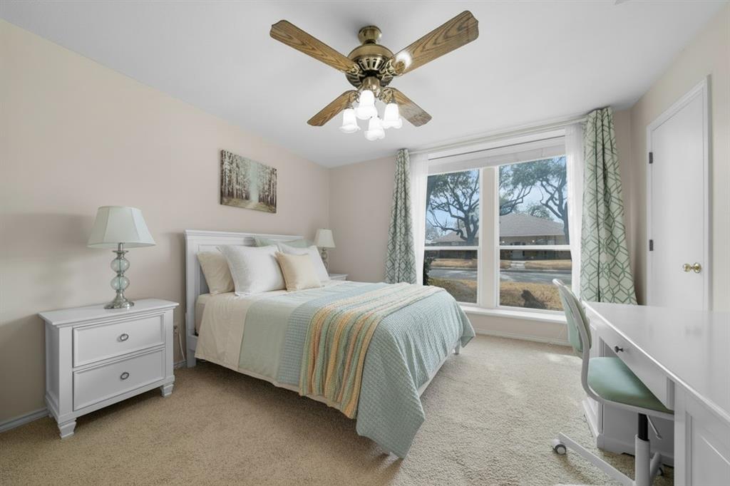 9727 Amberley Drive Dallas, TX 75243 - Photo 13 of 19 a spacious bedroom with a bed and a large window