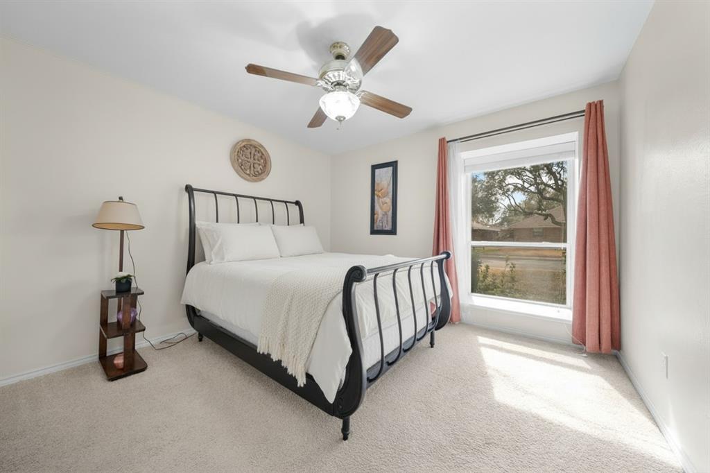 9727 Amberley Drive Dallas, TX 75243 - Photo 15 of 19 a bed room with a bed and a chandelier
