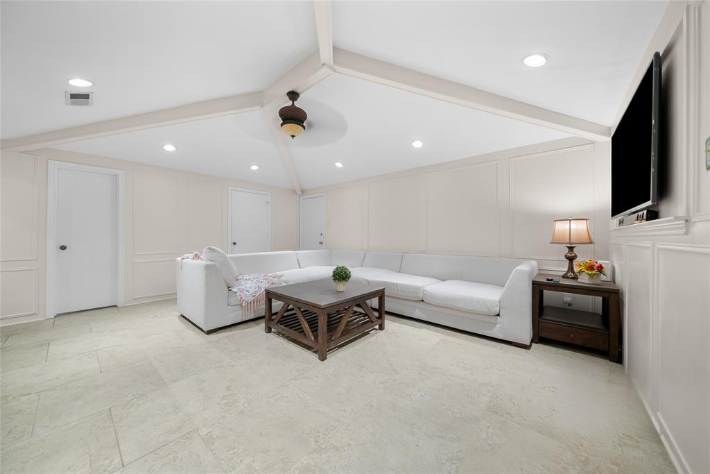 9727 Amberley Drive Dallas, TX 75243 - Photo 19 of 19 a living room with furniture and a flat screen tv