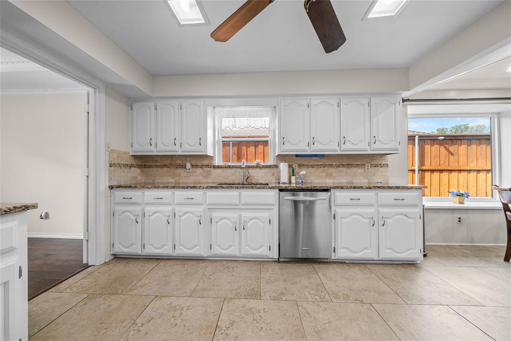 9727 Amberley Drive Dallas, TX 75243 - Photo 6 of 19 a kitchen with granite countertop white cabinets and white appliances