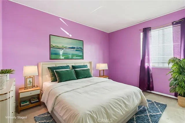 a bedroom with a bed and a potted plant