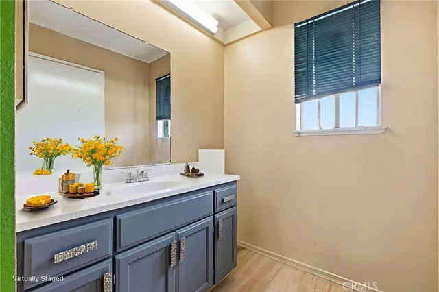 a bathroom with a granite countertop sink and a mirror