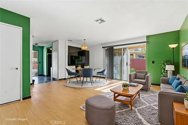 a living room with furniture a rug and a window