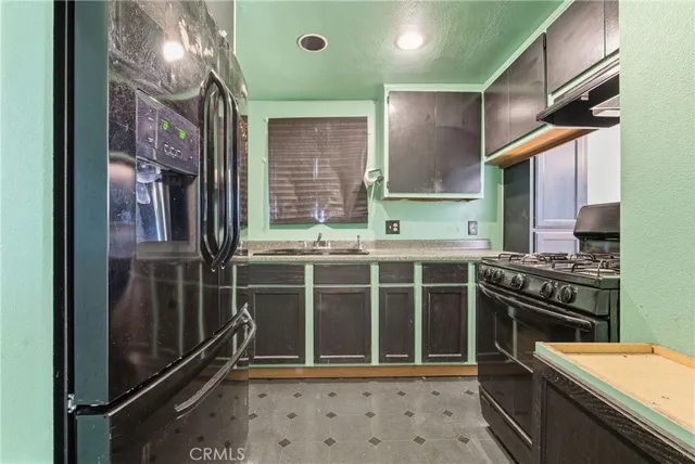 a kitchen with stainless steel appliances a stove and a refrigerator