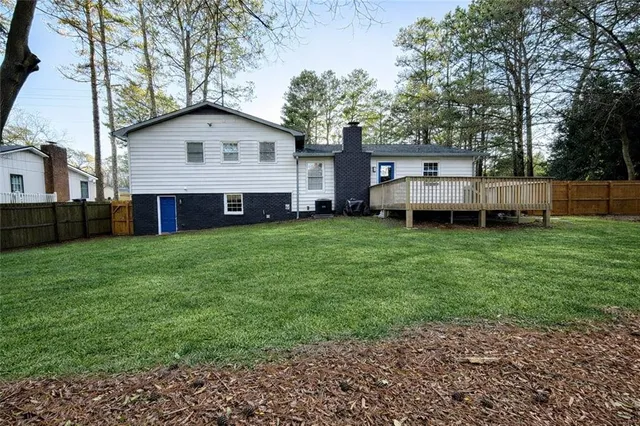a view of a house with a yard and sitting area