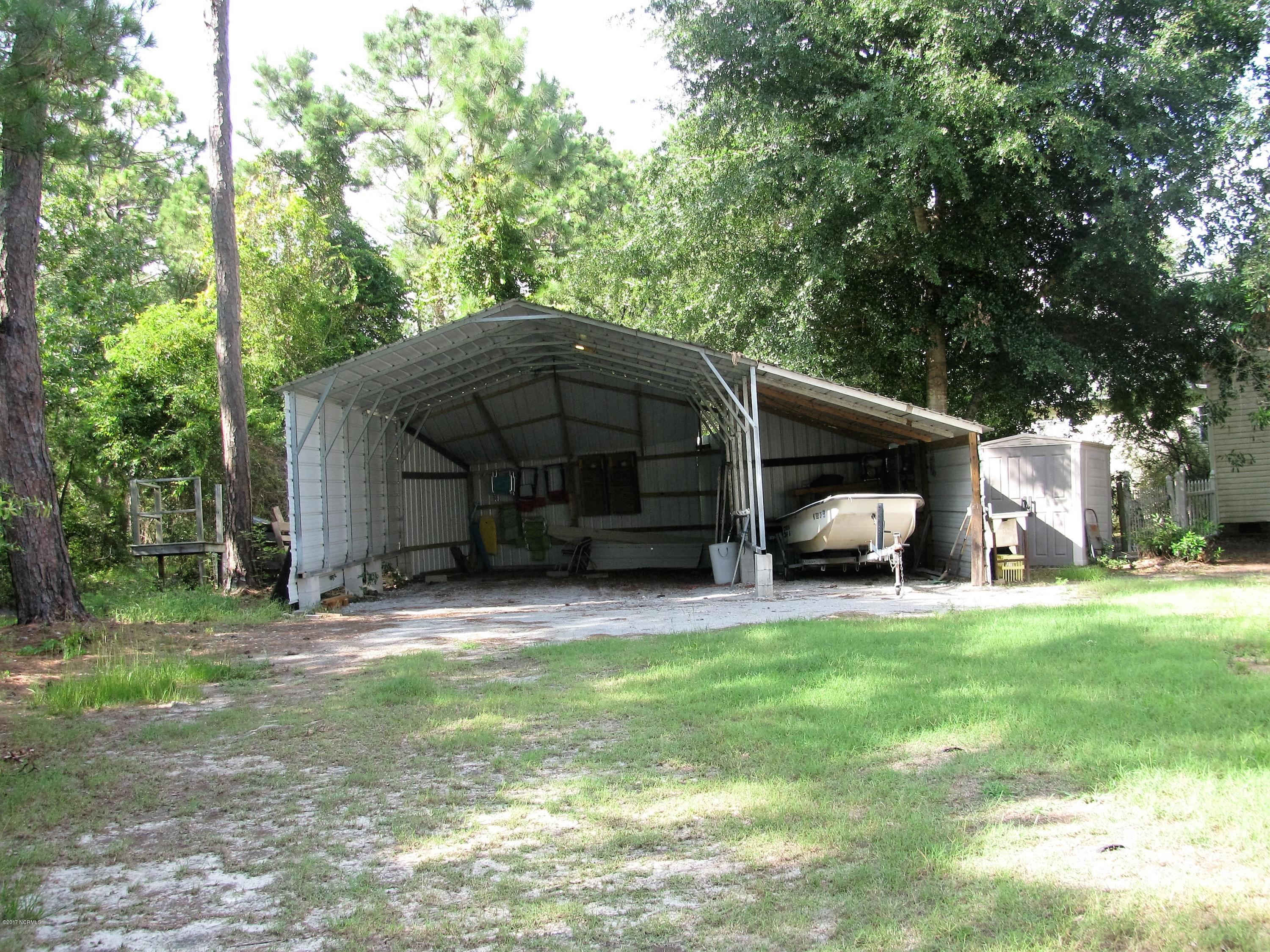 Large Boat/Car Port in Backyard-- accessed directly through gravel driveway on left.