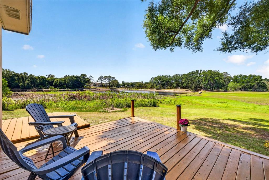 16330 Hanna Road Lutz, FL 33549 - Photo 31 of 41 a view of a patio with wooden floor and outdoor space