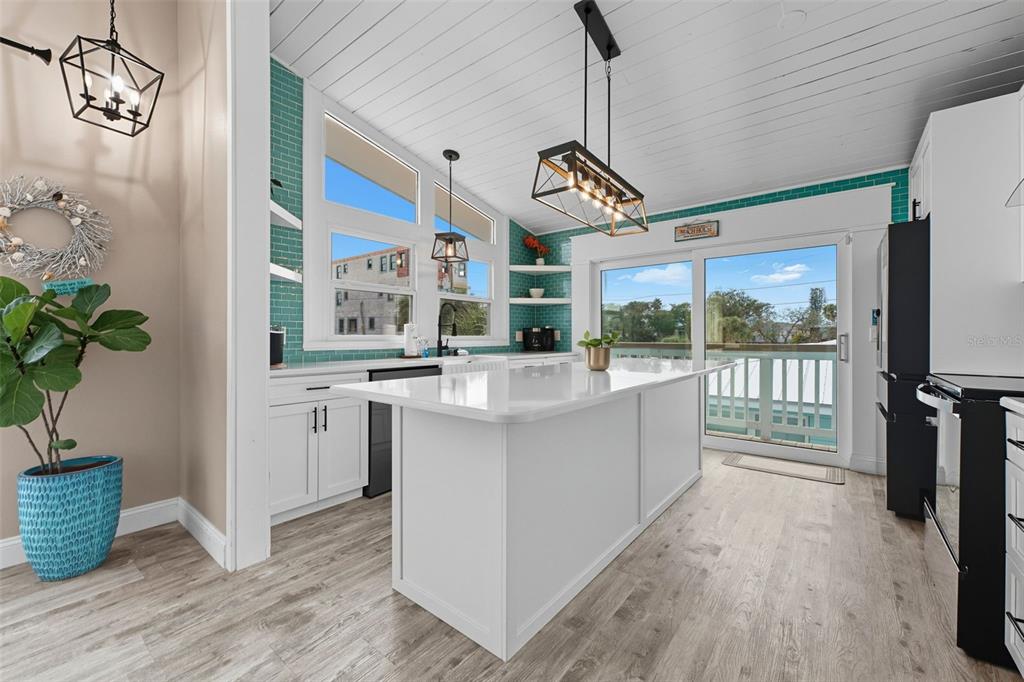 208 Bates Avenue Indian Rocks Beach, FL 33785 - Photo 12 of 47 a view of kitchen with furniture and large window