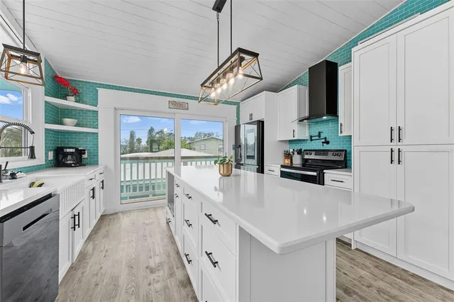 a kitchen with stainless steel appliances a sink a stove and a refrigerator