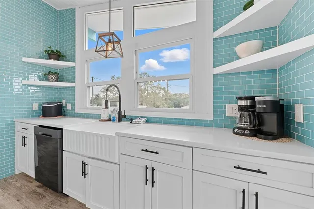 a kitchen with a sink cabinets and a window