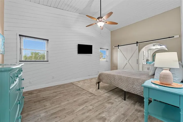 a bedroom with a bed window and a lamp