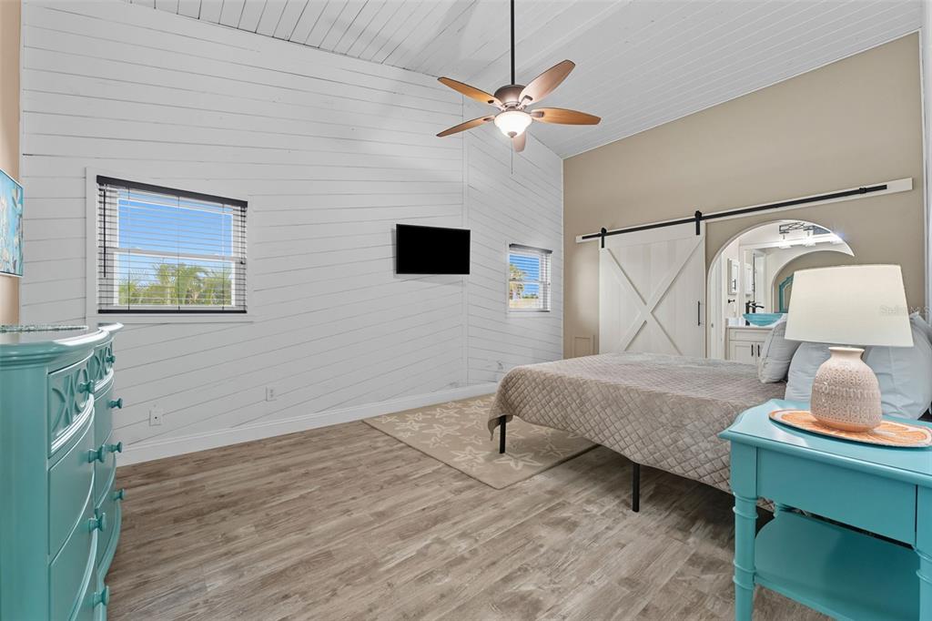 208 Bates Avenue Indian Rocks Beach, FL 33785 - Photo 16 of 47 a bedroom with a bed window and a lamp