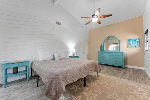 a bedroom with a bed a dresser and window