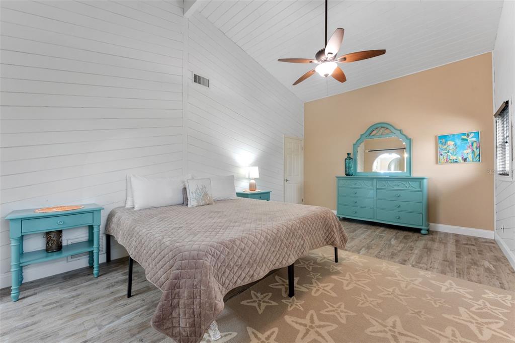 208 Bates Avenue Indian Rocks Beach, FL 33785 - Photo 17 of 47 a bedroom with a bed a dresser and window