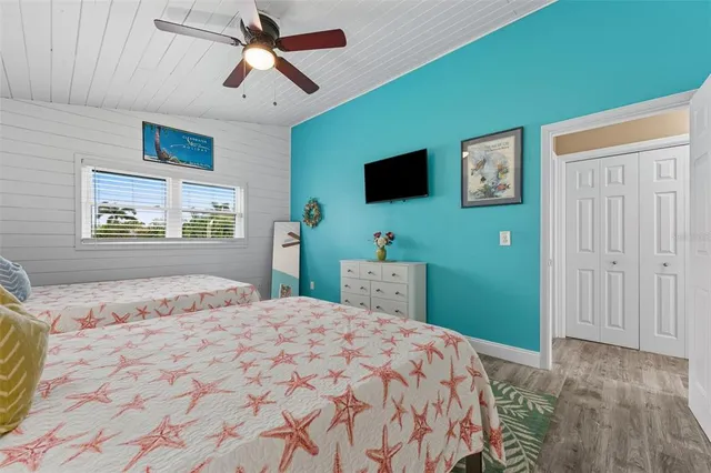 a bedroom with a bed and a flat screen tv