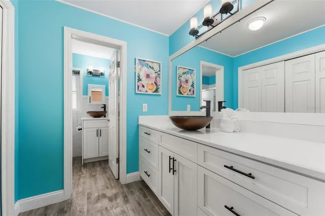 a kitchen with stainless steel appliances white cabinets and window