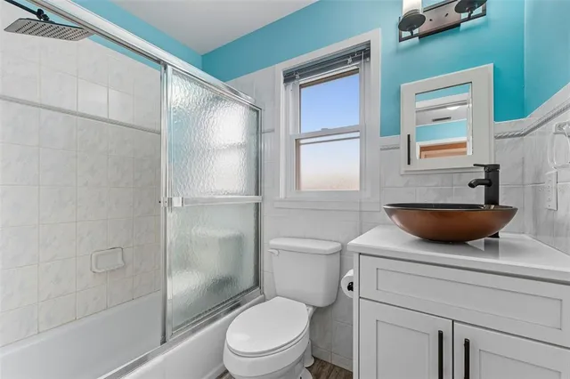 a bathroom with a toilet a sink and shower